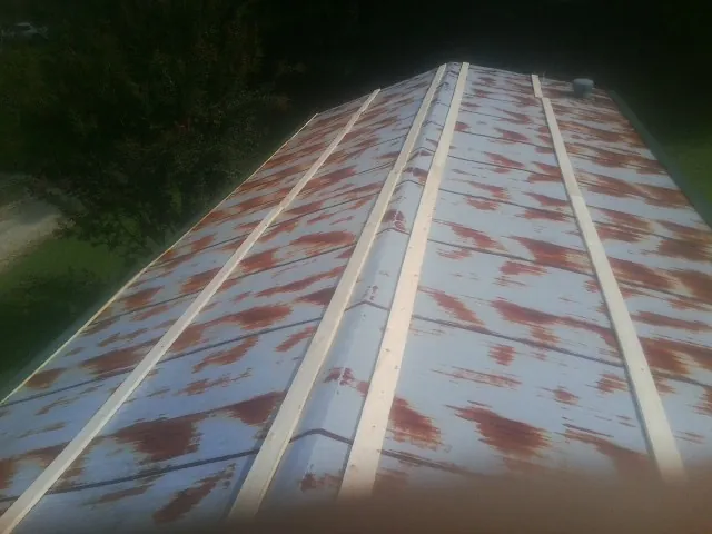 Rusted metal roof panels with new wood purlins before replacement — Storm Damage Roof Repair in Rahway by Roofing Brothers