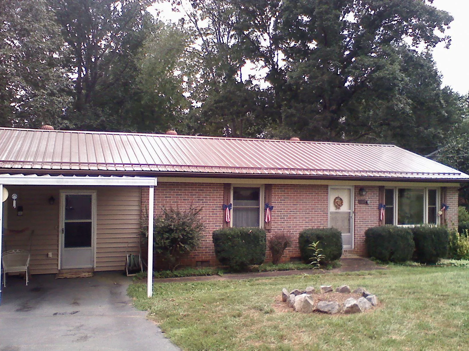 Bronze metal roof and carport on a brick ranch home — Roof Repair work by our crew in Rahway