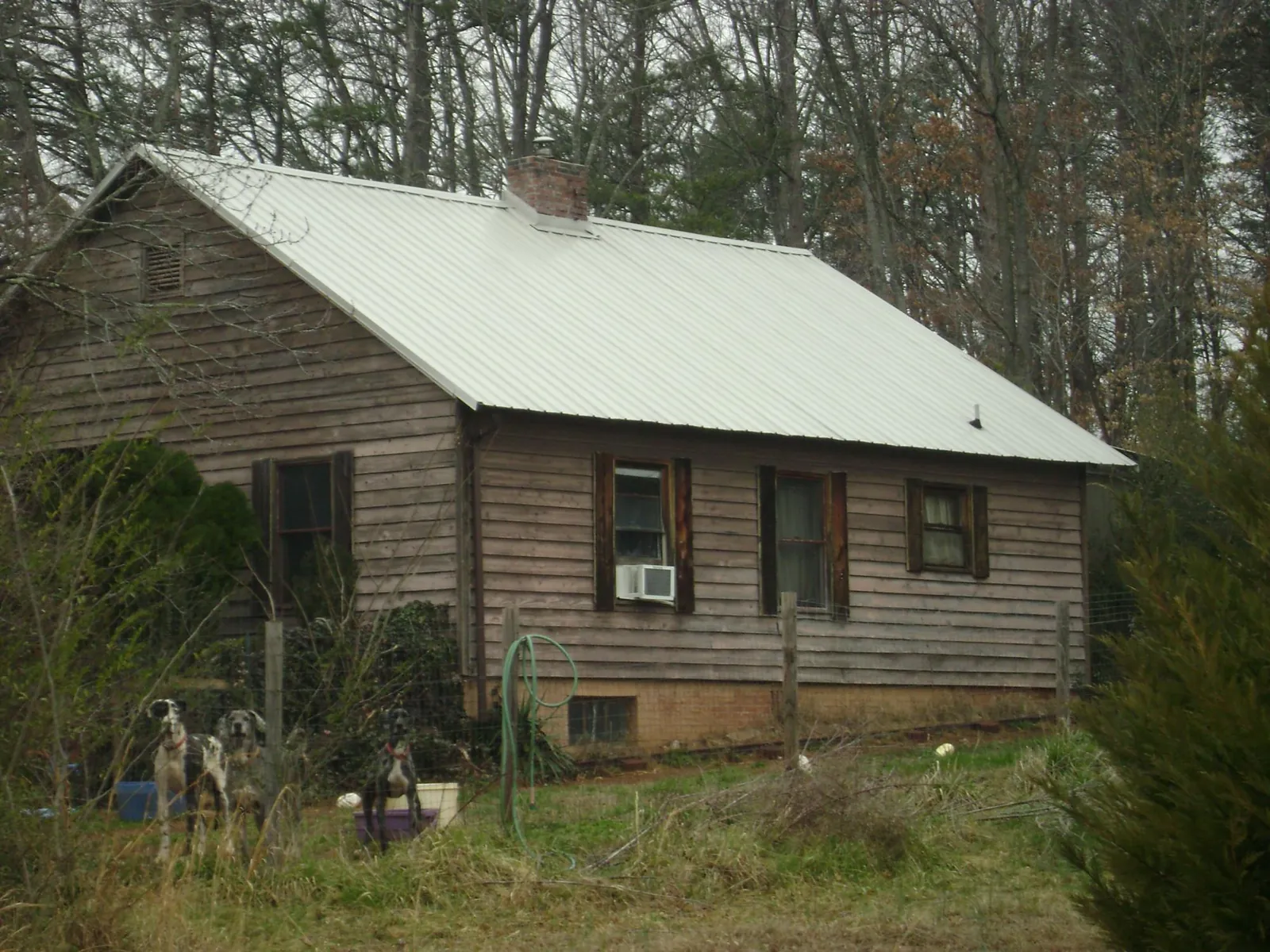 White metal roof on an old wood sided farmhouse, from a Metal Roof Installation job in Rahway
